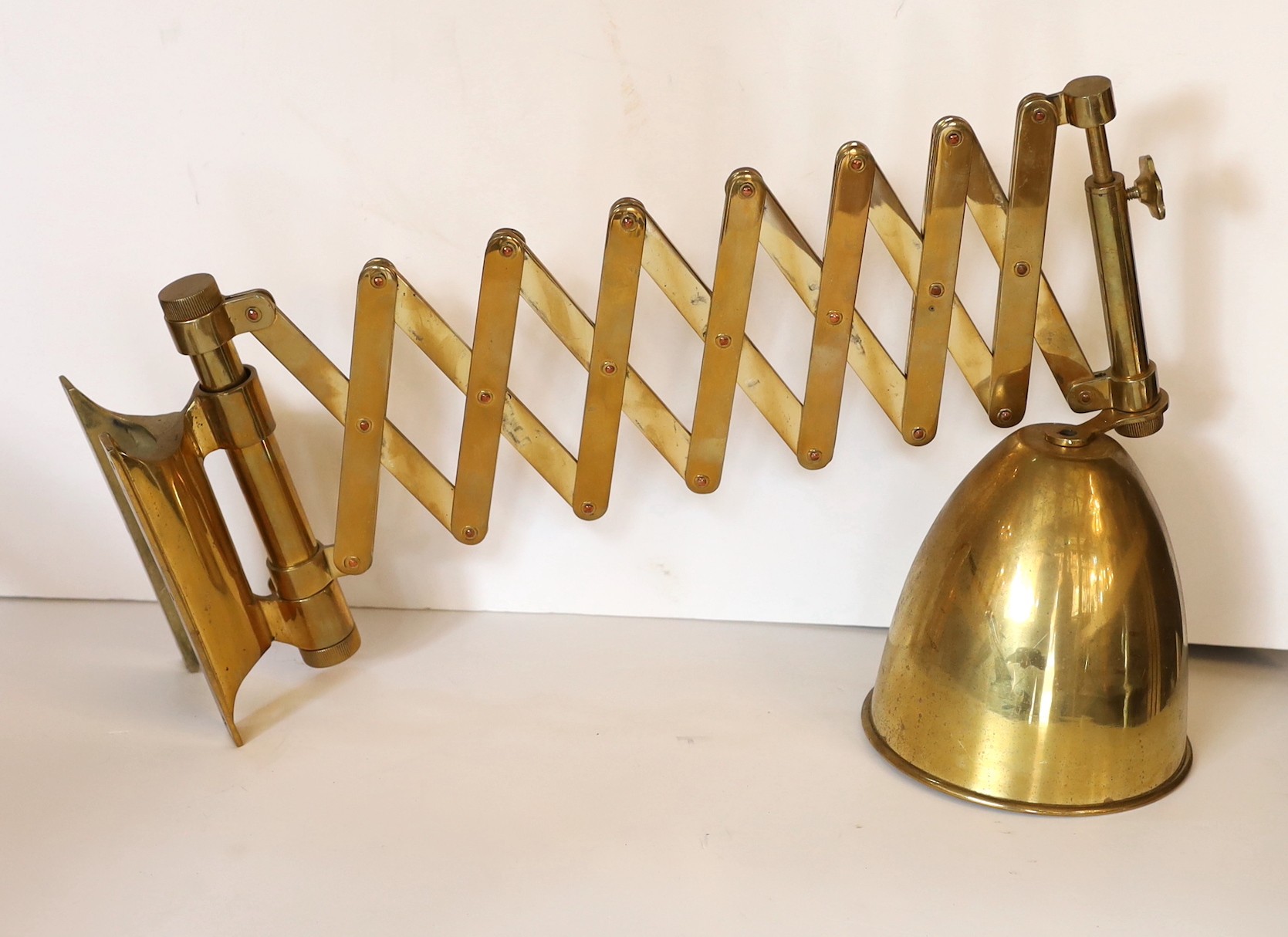 An early 20th century style black and brass expanding wall light, height 34cm